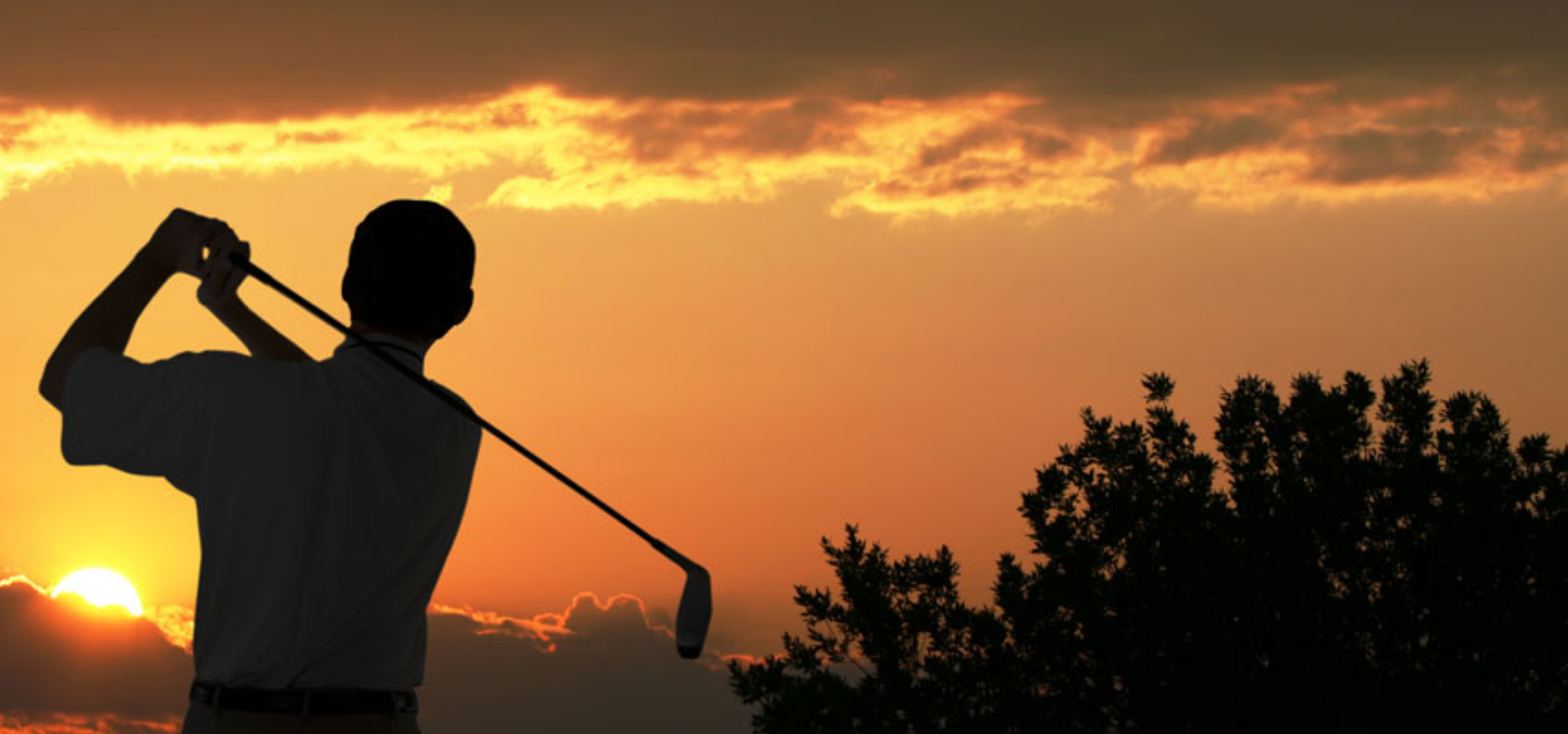 view of golfer at sunset
